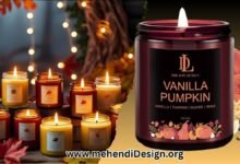 A collection of various best fall scented candles with warm, cozy lighting and autumnal decoration in the background