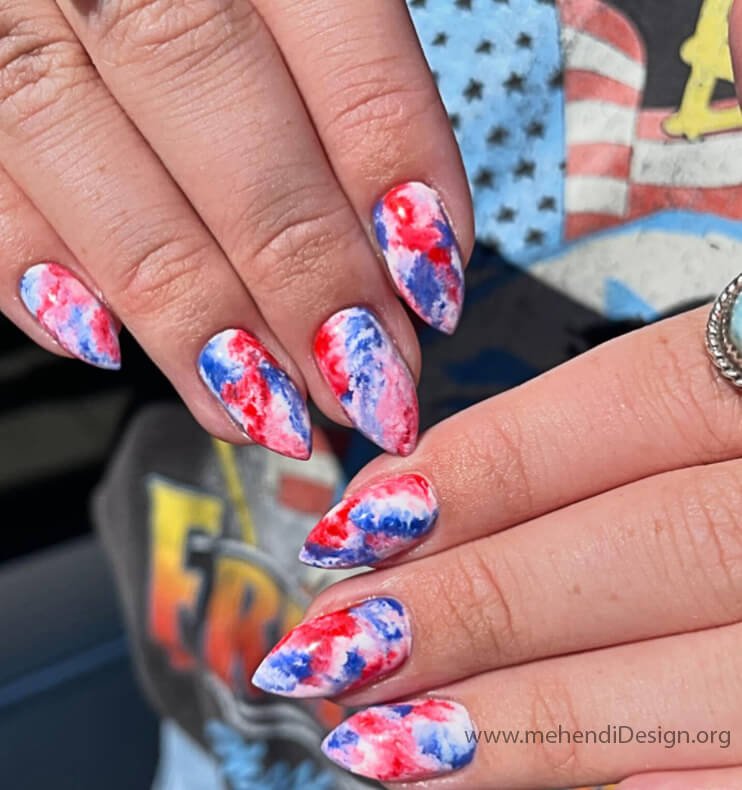 Image of A fun and colorful red white and blue tie dye nail design A fun and colorful red, white, and blue tie-dye nail design