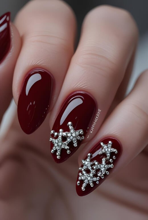 Image of An elegant red manicure with sparkling rhinestone star accents for a touch of glam An elegant red manicure with sparkling rhinestone star accents for a touch of glam