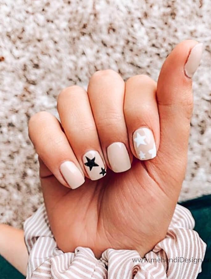 Image of Minimalist Labor Day nails with a simple negative space star design Minimalist Labor Day nails with a simple negative space star design
