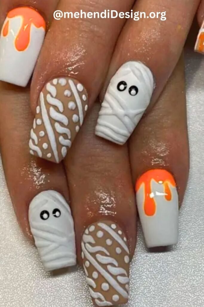 Image of Playful mummy wrap acrylic nails with googly eyes a unique halloween design Playful mummy wrap acrylic nails with googly eyes, a unique halloween design